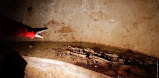 Researcher shows remains inside a tomb opened in the stone church floor above the family crypt of Florentine silk merchant del Giocondo in the Santissima Annunziata basilica in Florence
