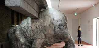 A clay sculpture of an elephant crashing into a wall forms part of the exhi