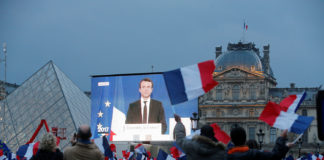 President Elect Emmanuel Macron is seen on a giant screen near the Louvre museum after results were announced in the second round vote of the 2017 French presidential elections