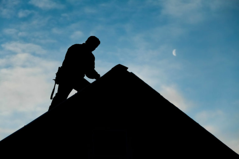 contractor-in-silhouette-working-on-a-roof-top-PFBKLZ8-1-1-scaled-2